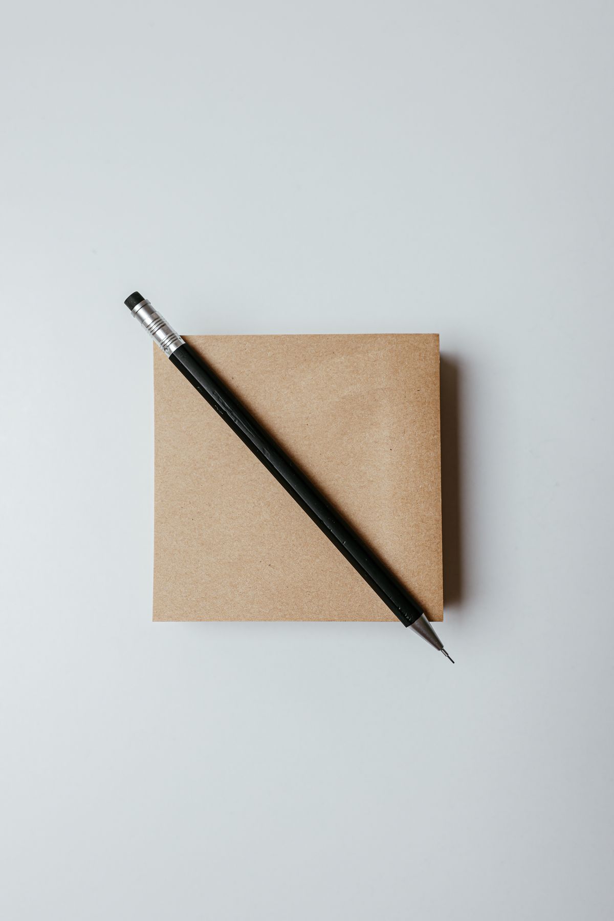 Brown notepad with a pen on a white surface