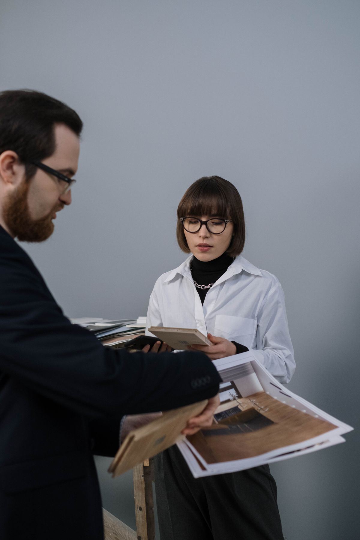 Two colleagues reviewing project materials together indoors