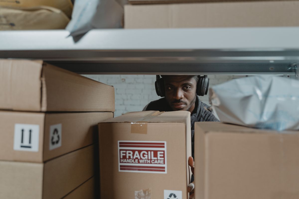 Warehouse worker inspecting fragile packages