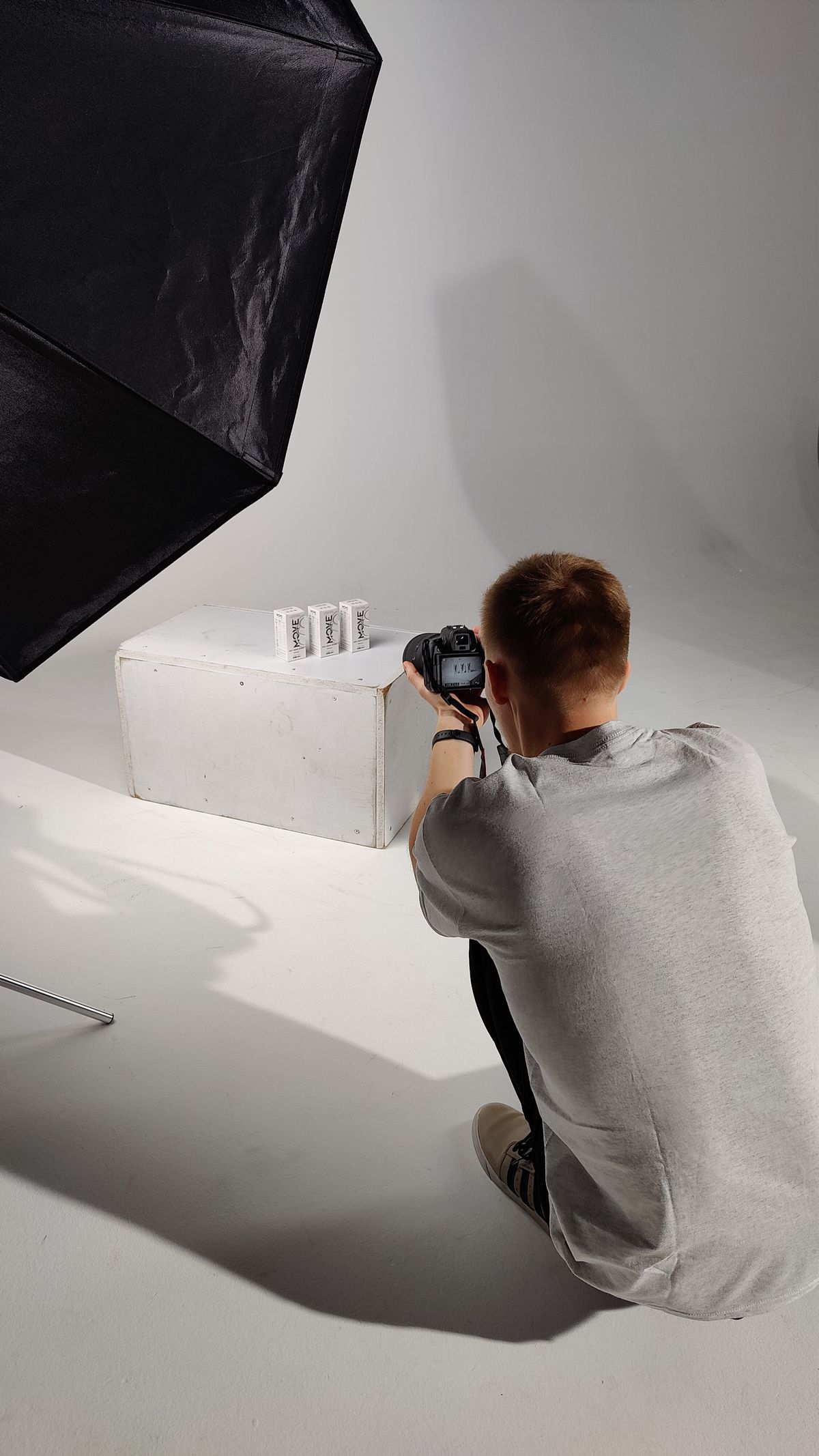 Photographer setting up a product photoshoot in a studio